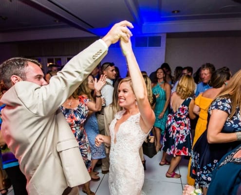 A Bride and Groom Dancing in the Center of Guests One