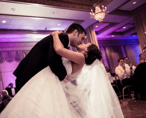 A Bride and Groom Kissing While Dancing