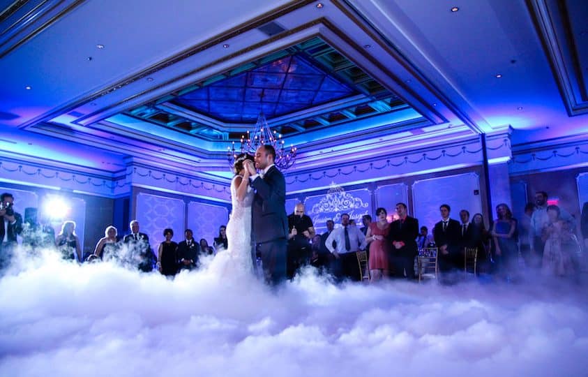 A Bride and Groom Dancing on Smoke in Blue Light