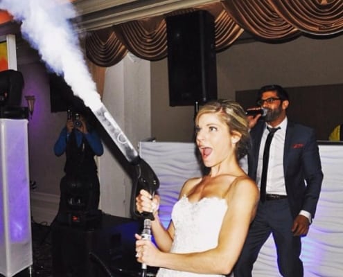 A Bride Blowing Smoke With a Smoke Gun