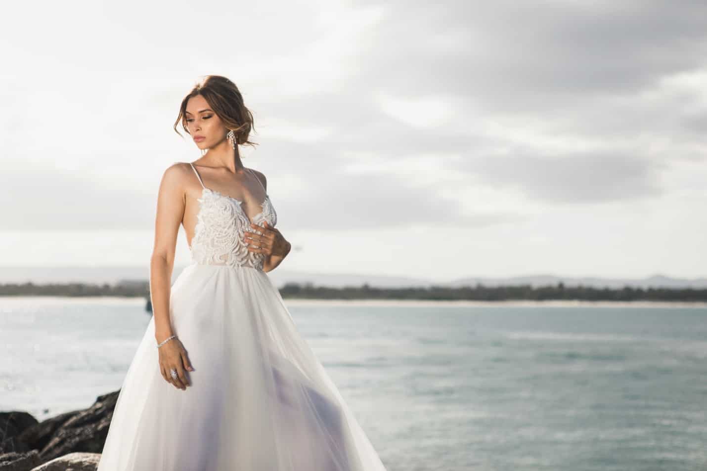 A Bride in a White Dress Infront of the Beach