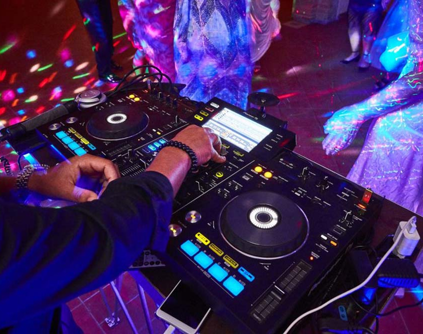 A DJ Controlling Music on his Console