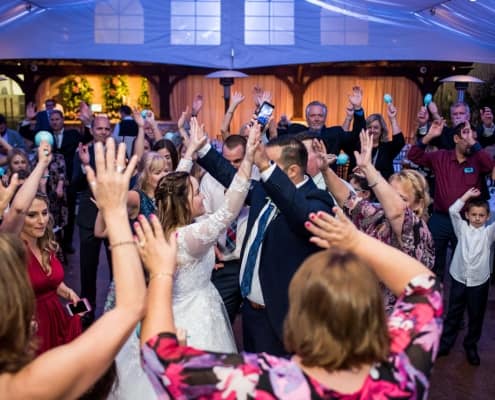 A Group of People Dancing Around the Bride and Groom